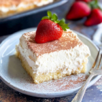 Homemade tres leches cake slice with whipped cream