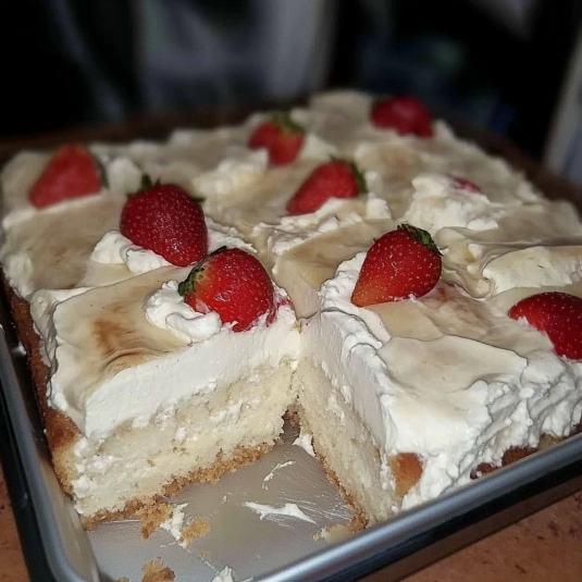 Whipped cream topping on tres leches cake