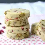 Cranberry pistachio shortbread cookies stacked on plate