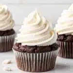 Marshmallow frosting piped onto cupcake