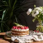Pistachio raspberry cake slice with berries and nuts