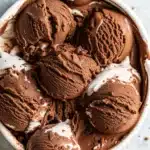 Scoop of chocolate marshmallow ice cream in a rustic bowl
