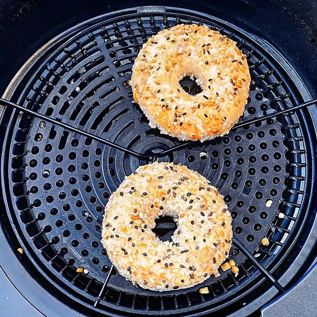 Fresh homemade cottage cheese bagels cooling on a wire rack