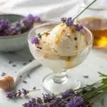 Creamy lavender ice cream with lavender flowers and honey drizzle