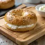 Protein bagels with Greek yogurt on wooden board