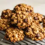 Soft and chewy 3‑ingredient oatmeal cookies with chocolate chips cooling on a wire rack.