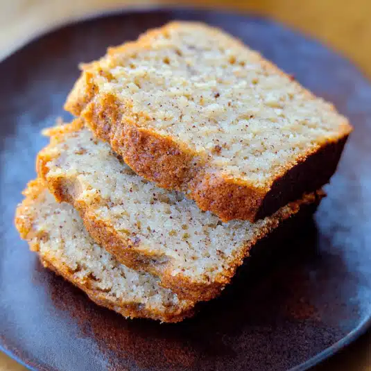 almond flour banana bread loaf sliced open on a wooden board