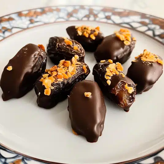 Chocolate covered dates with sea salt on tray