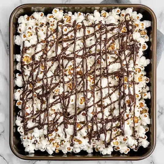 freshly popped popcorn drizzled with melted dark chocolate