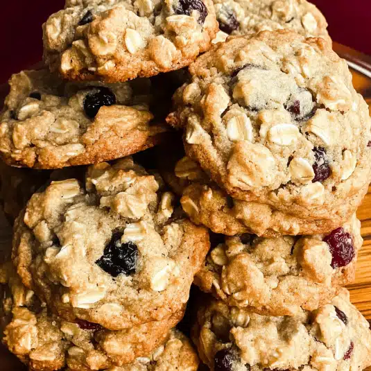 chewy cranberry oatmeal cookies on rustic tray