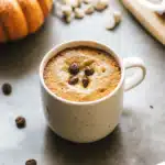 Pumpkin mug cake topped with whipped cream and cinnamon