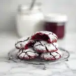 Red Velvet Crinkle Cookies fresh from the oven with powdered sugar coating
