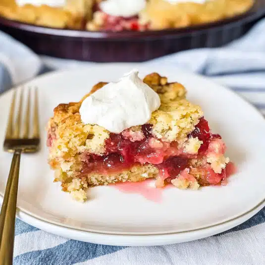 Freshly baked rhubarb dump cake with golden crust in white baking dish
