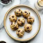 Plate of cookie dough protein bites with chocolate chips, a no bake high protein snack that is gluten free and easy to make at home.
